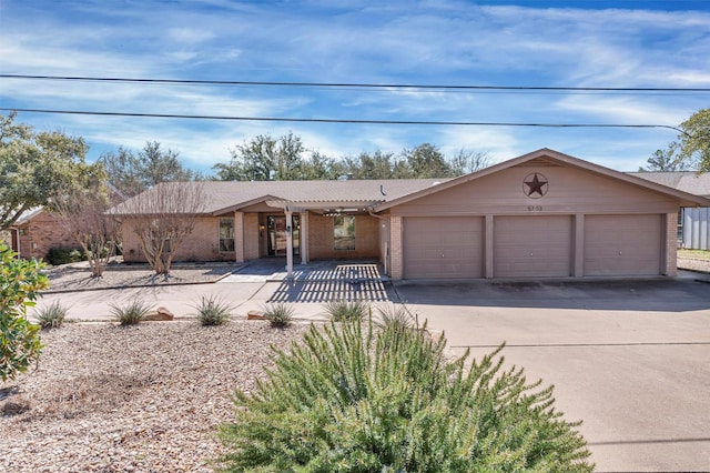 view of front facade with a garage, concrete driveway, and brick siding