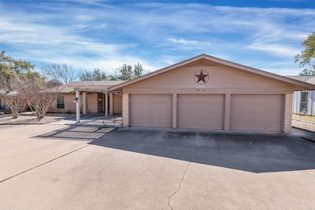 single story home featuring a garage, brick siding, and a pergola