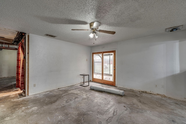 unfurnished room featuring a ceiling fan, concrete floors, visible vents, and a textured ceiling