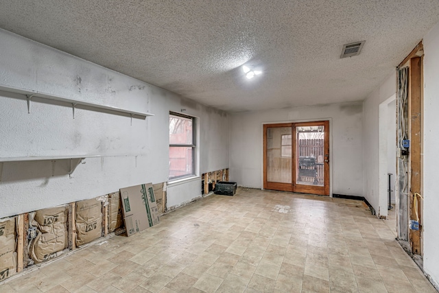 empty room with visible vents and a textured ceiling