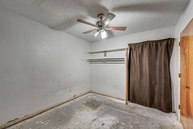 unfurnished bedroom with a ceiling fan, unfinished concrete flooring, and a textured ceiling