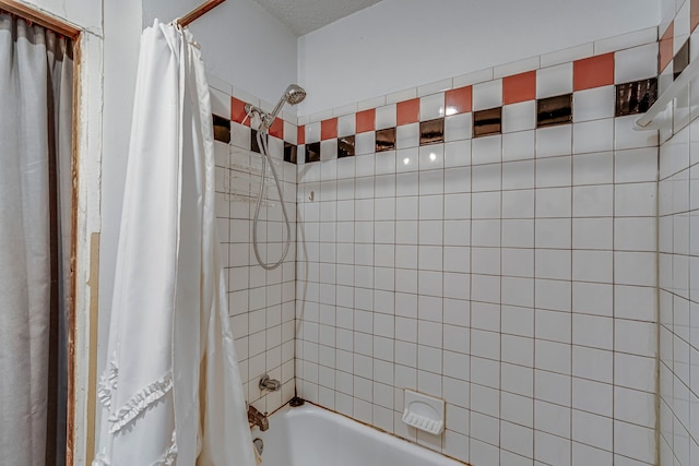 bathroom with shower / bath combo with shower curtain