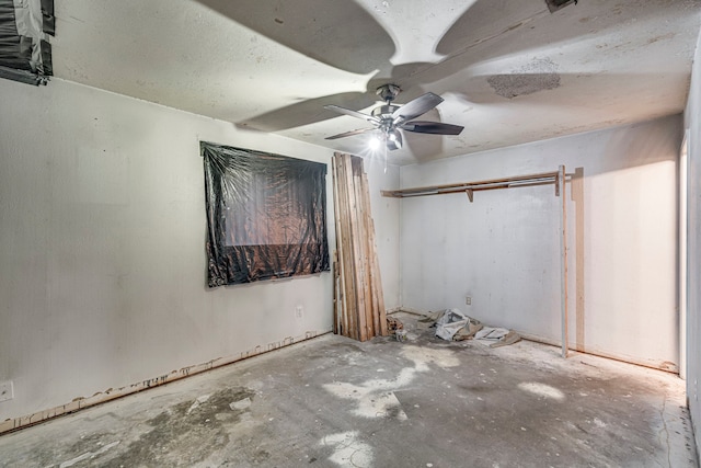 unfurnished bedroom featuring ceiling fan and concrete flooring