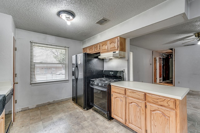 kitchen featuring visible vents, a peninsula, under cabinet range hood, light countertops, and black appliances