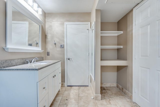 bathroom with tile patterned floors, baseboards, and vanity