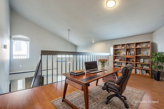 office space featuring high vaulted ceiling and wood finished floors