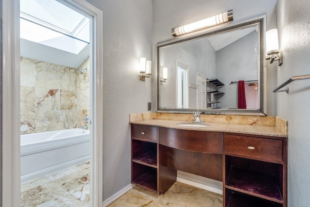 bathroom featuring lofted ceiling with skylight, vanity, baseboards, and shower / bathtub combination