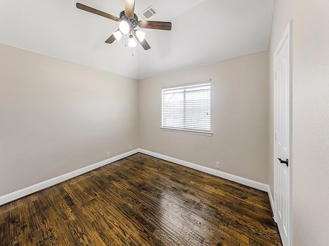 unfurnished room featuring lofted ceiling, ceiling fan, dark wood finished floors, and baseboards