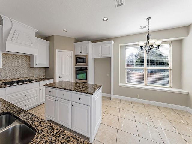 kitchen featuring light tile patterned floors, stainless steel appliances, tasteful backsplash, visible vents, and white cabinetry