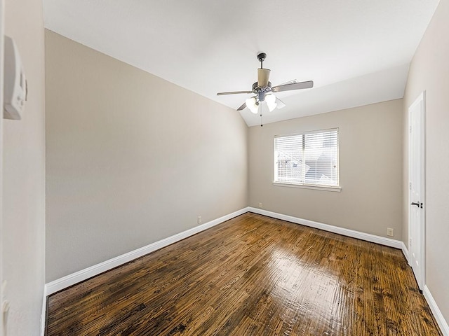 unfurnished room with vaulted ceiling, ceiling fan, wood finished floors, and baseboards