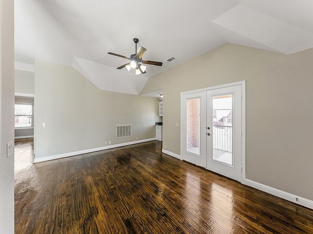 unfurnished living room with vaulted ceiling, french doors, wood finished floors, and visible vents