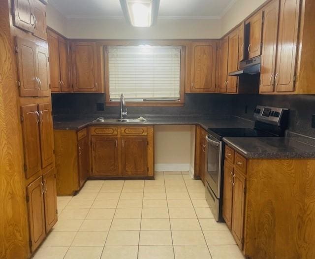 kitchen with under cabinet range hood, brown cabinets, a sink, and stainless steel range with electric cooktop