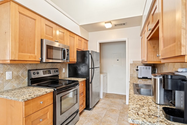 kitchen featuring light tile patterned floors, visible vents, appliances with stainless steel finishes, light stone countertops, and tasteful backsplash