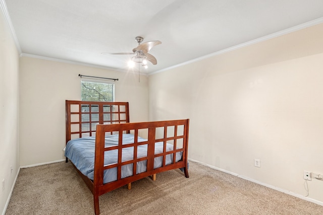 carpeted bedroom featuring ornamental molding, ceiling fan, and baseboards