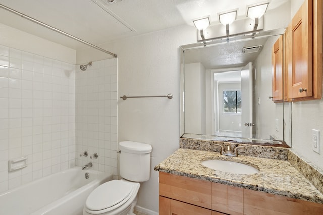 bathroom with visible vents, a textured wall, toilet, vanity, and shower / washtub combination