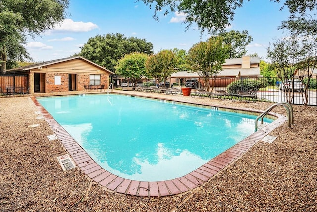 community pool featuring a patio area and fence