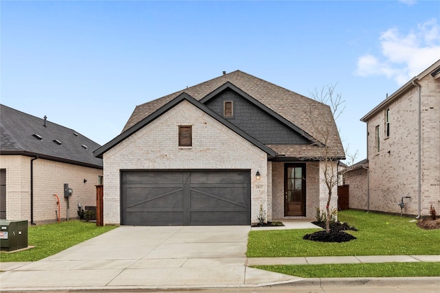 view of front of home featuring brick siding, roof with shingles, an attached garage, driveway, and a front lawn