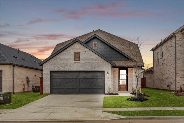 view of front of property with brick siding, roof with shingles, concrete driveway, an attached garage, and a front lawn