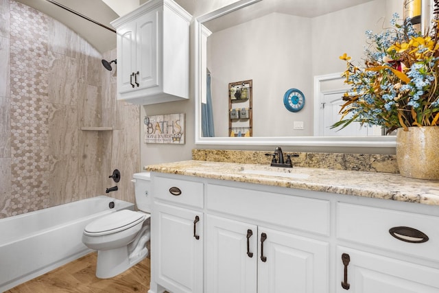 full bath with wood finished floors, vanity, toilet, and shower / bathtub combination