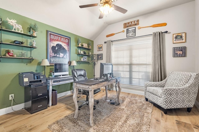 office featuring lofted ceiling, baseboards, and wood finished floors