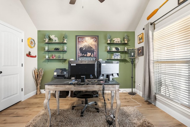 home office with light wood finished floors, baseboards, vaulted ceiling, and a ceiling fan