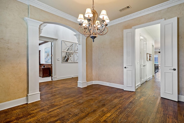 unfurnished dining area with ornate columns, crown molding, visible vents, and wood finished floors