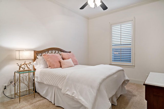 carpeted bedroom with baseboards, ceiling fan, and crown molding