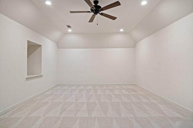 additional living space with lofted ceiling, light carpet, visible vents, and recessed lighting