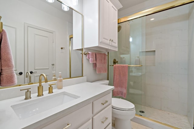 bathroom featuring toilet, a shower stall, tile patterned flooring, and vanity