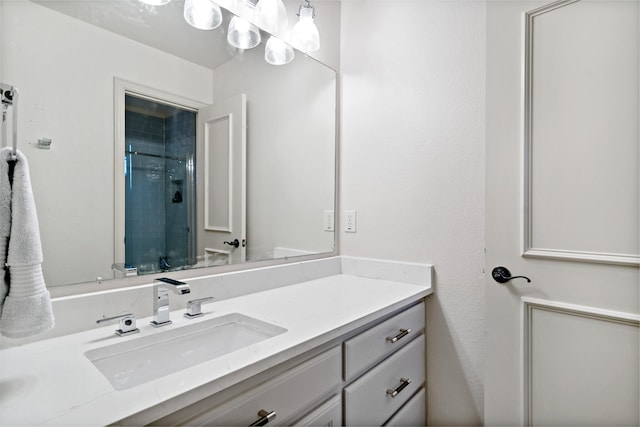 full bath with a shower stall and vanity