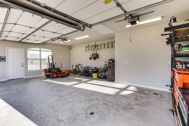 garage featuring baseboards and a garage door opener