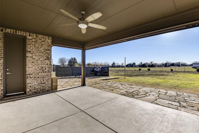 view of patio / terrace with fence and a ceiling fan