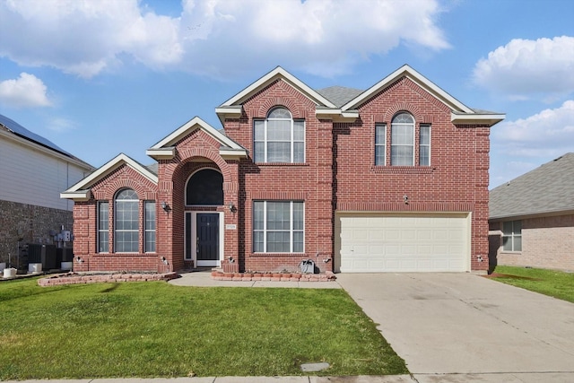 traditional home featuring an attached garage, concrete driveway, brick siding, and a front yard