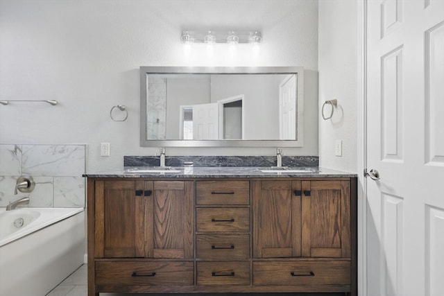 bathroom with double vanity, a tub, a sink, and tile patterned floors