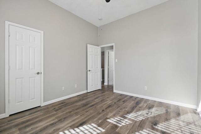 unfurnished bedroom featuring baseboards and wood finished floors