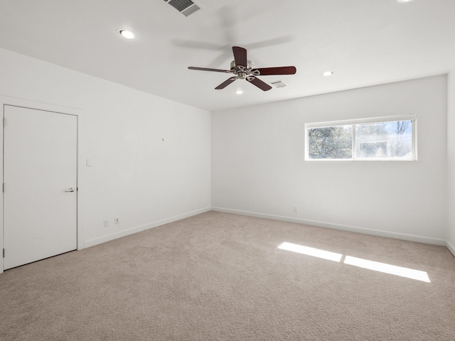 unfurnished room with light colored carpet, visible vents, baseboards, and recessed lighting