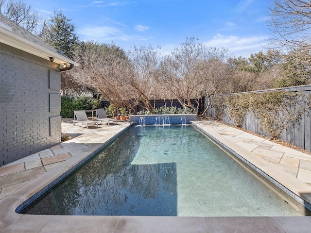 view of swimming pool with a patio area, a fenced backyard, and a fenced in pool