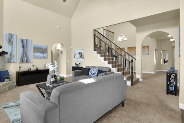 living room featuring arched walkways, stairway, carpet, high vaulted ceiling, and a notable chandelier