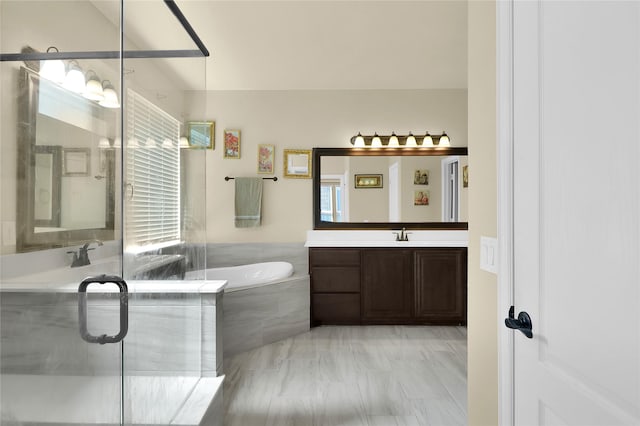 bathroom with a stall shower, vanity, and a bath