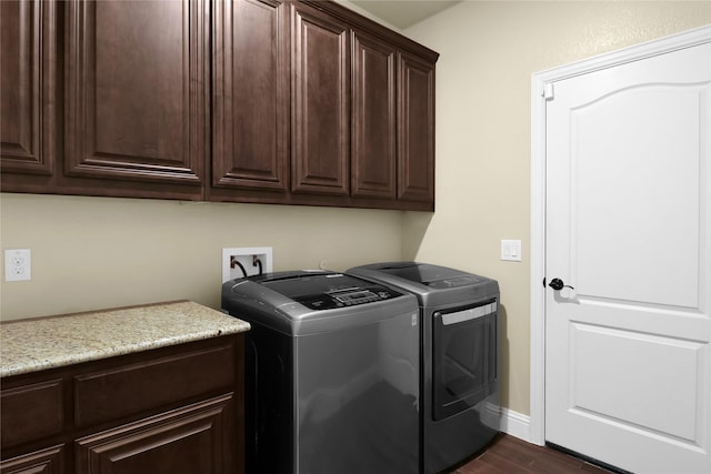 laundry room with cabinet space, baseboards, dark wood-style floors, and separate washer and dryer