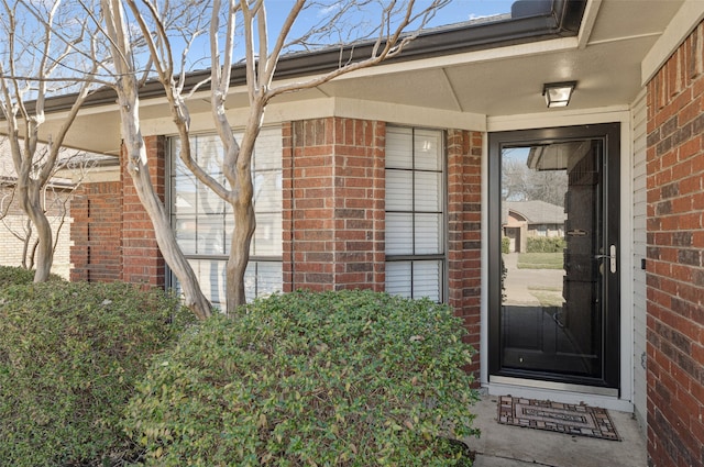 property entrance featuring brick siding