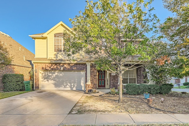 view of front of home with a garage, concrete driveway, and brick siding