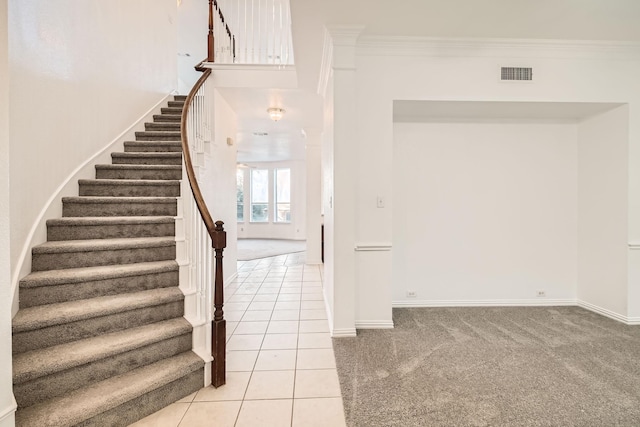 stairway featuring ornamental molding, visible vents, and carpet floors