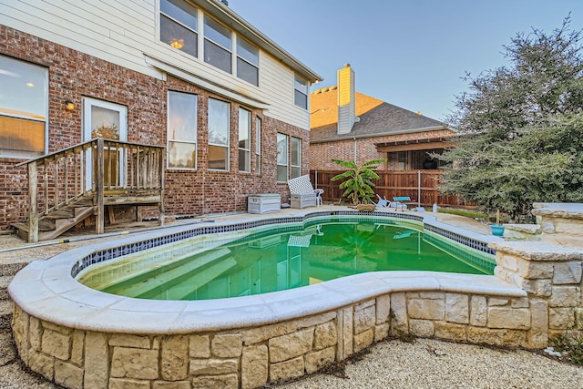 view of pool featuring a patio area, fence, and a fenced in pool