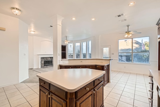 kitchen featuring a wealth of natural light, light countertops, visible vents, and a kitchen island