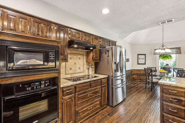 kitchen featuring visible vents, wainscoting, dark wood-style flooring, under cabinet range hood, and black appliances