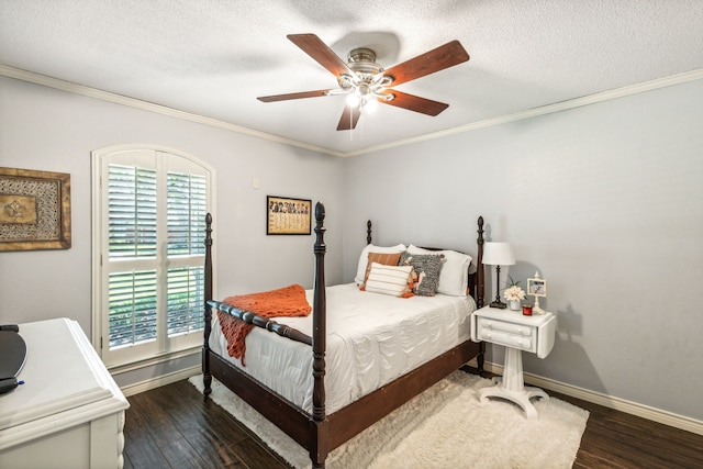 bedroom with crown molding, a textured ceiling, baseboards, and wood finished floors