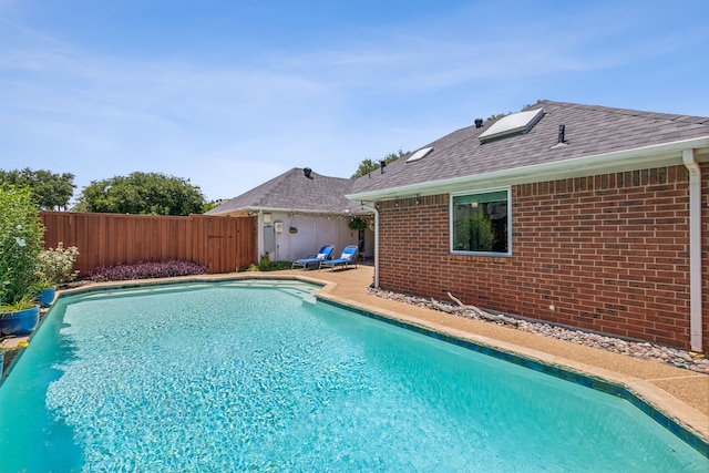 view of swimming pool featuring a patio area, fence, and a fenced in pool