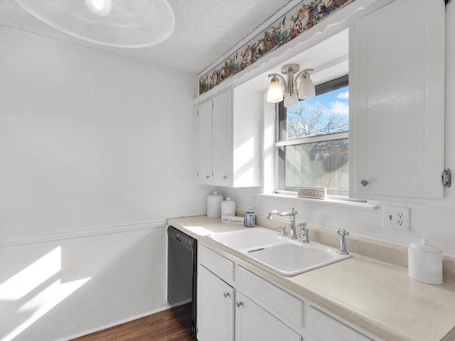 kitchen featuring a sink, white cabinets, dishwasher, and light countertops