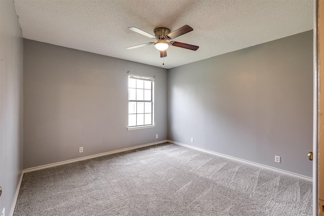 carpeted spare room with ceiling fan, a textured ceiling, and baseboards